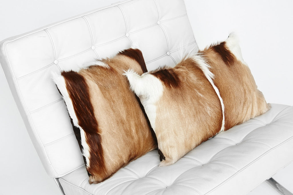 Spring Bok Fur Pillows on a White Barcelona Chair