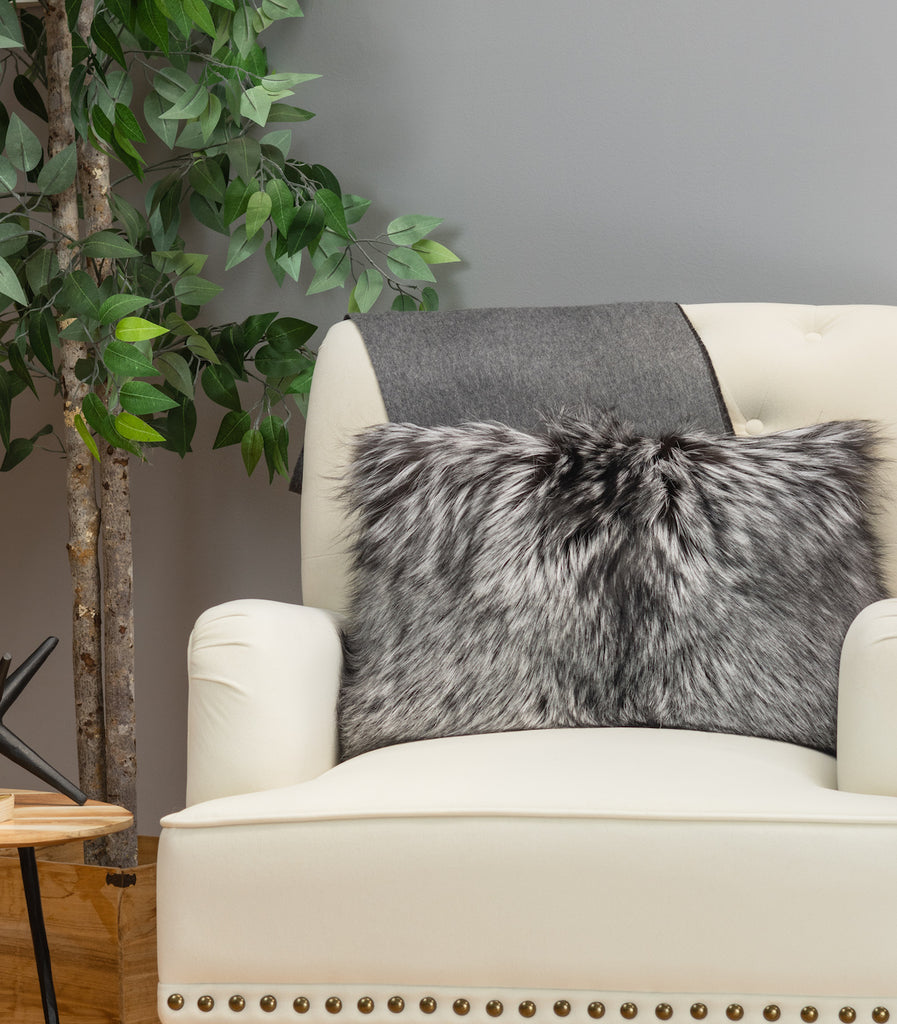 Silver fox fur pillow on white sofa chair in living room
