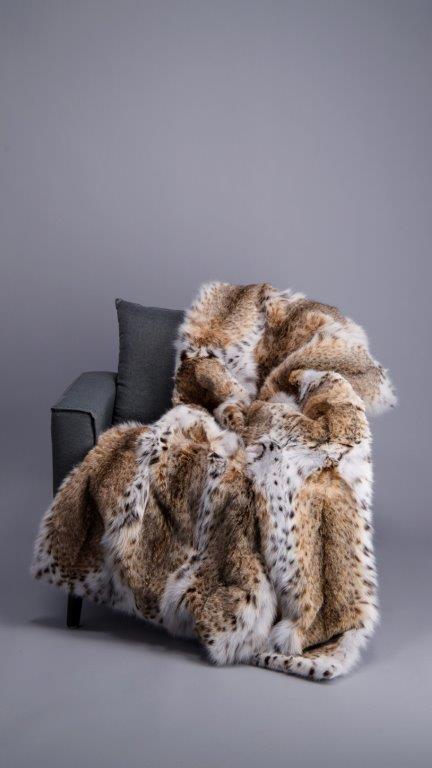 american lynx fur blanket draped over living room couch for interior design