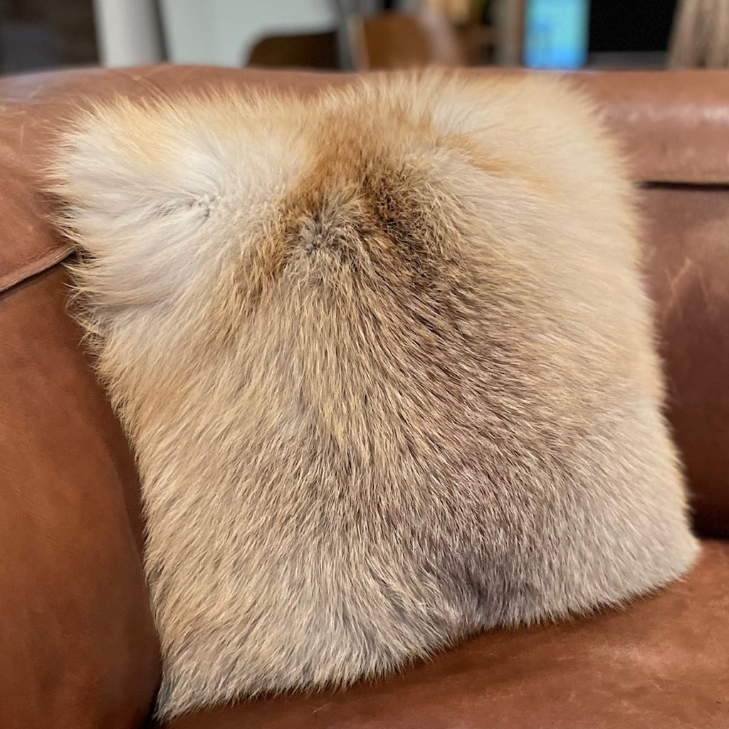 Golden Island Fox fur Pillow on leather couch interior design