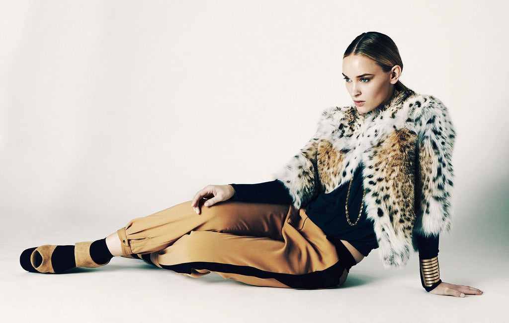model wearing lynx bolero sitting down in trouser style pants