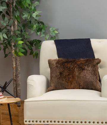 beaver fur pillow on white sofa chair in living room