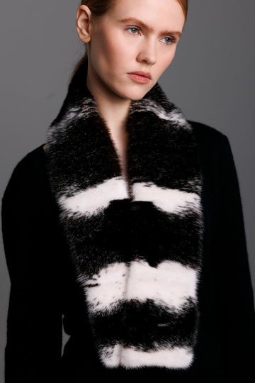 black and white cross mink scarf worn on woman with black cashmere sweater