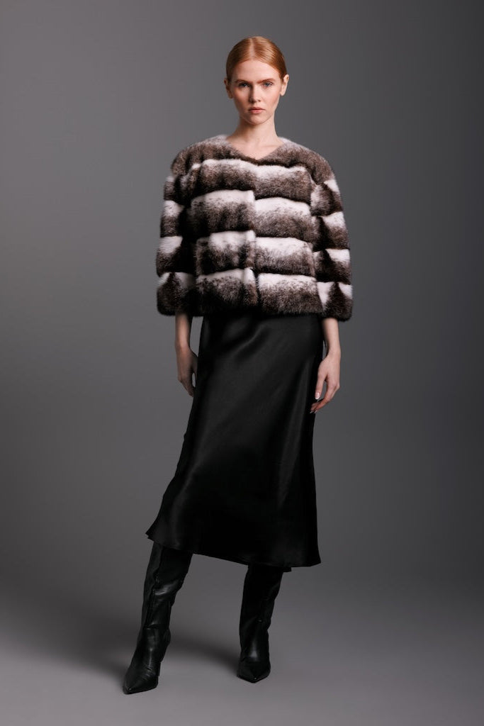 black cross mink jacket  in horizontal pattern on woman wearing a silk dress