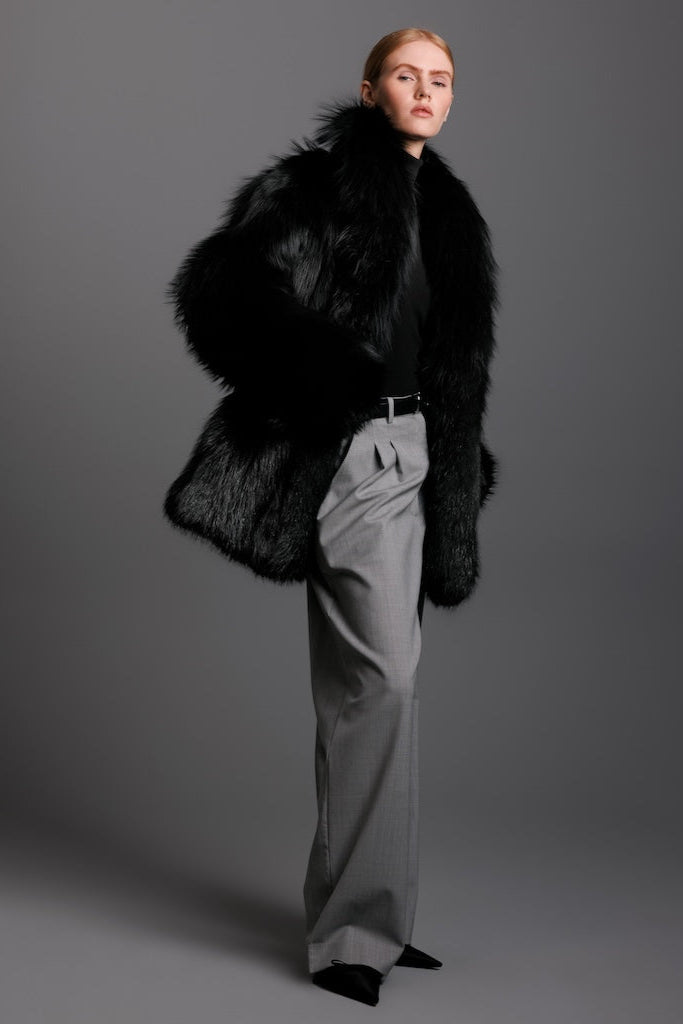 black dyed sivler fox jacket pocket detail on woman wearing grey pants