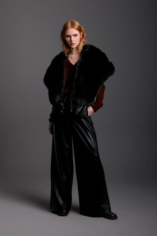 black fox fur shrug worn on woman with black leather pants in full frontal view