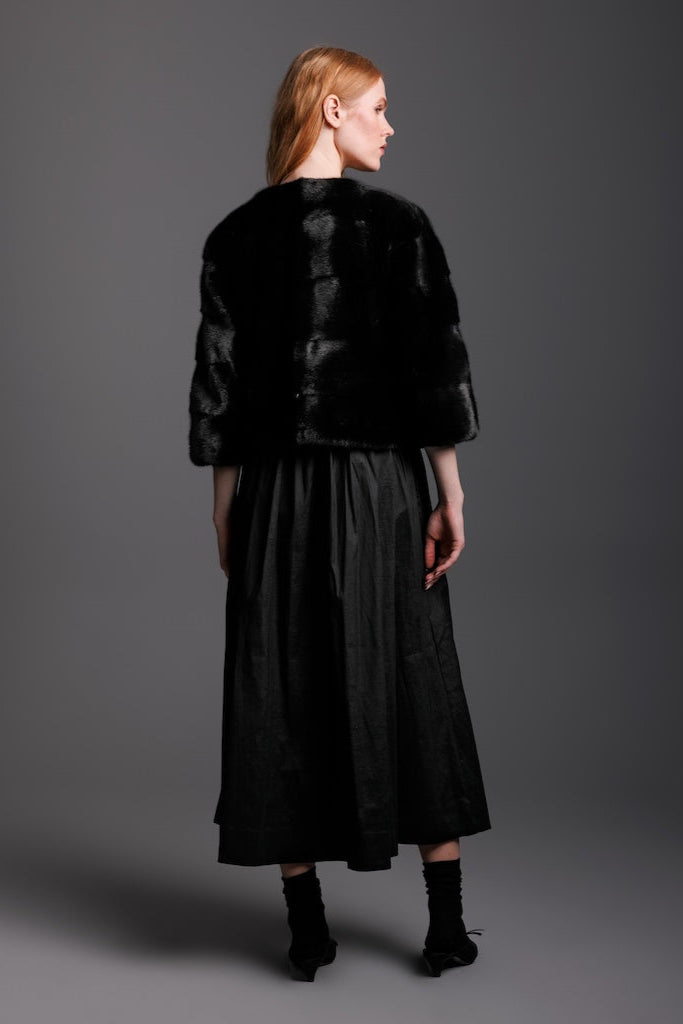 black ranch mink bolero jacket on woman wearing black dress backside view