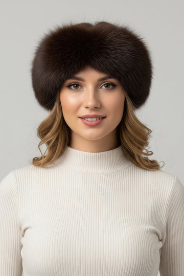 Woman wearing a brown fox fur headband with velcro closure and white winter sweater