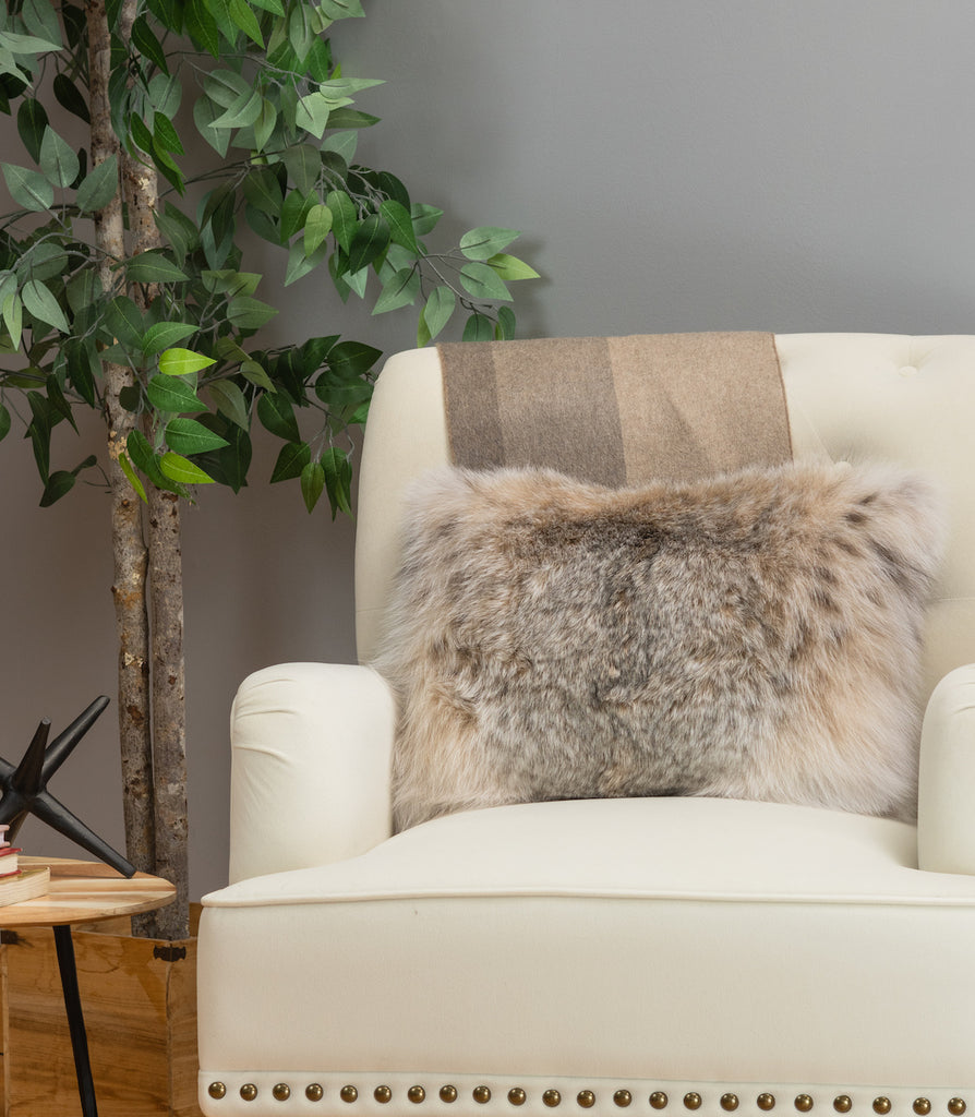 canadian lynx fur pillow on white sofa chair in living room