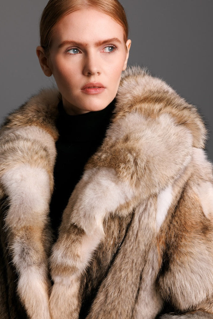 woman wearing coyote fur jacket and black turtleneck with a closeup of the fur