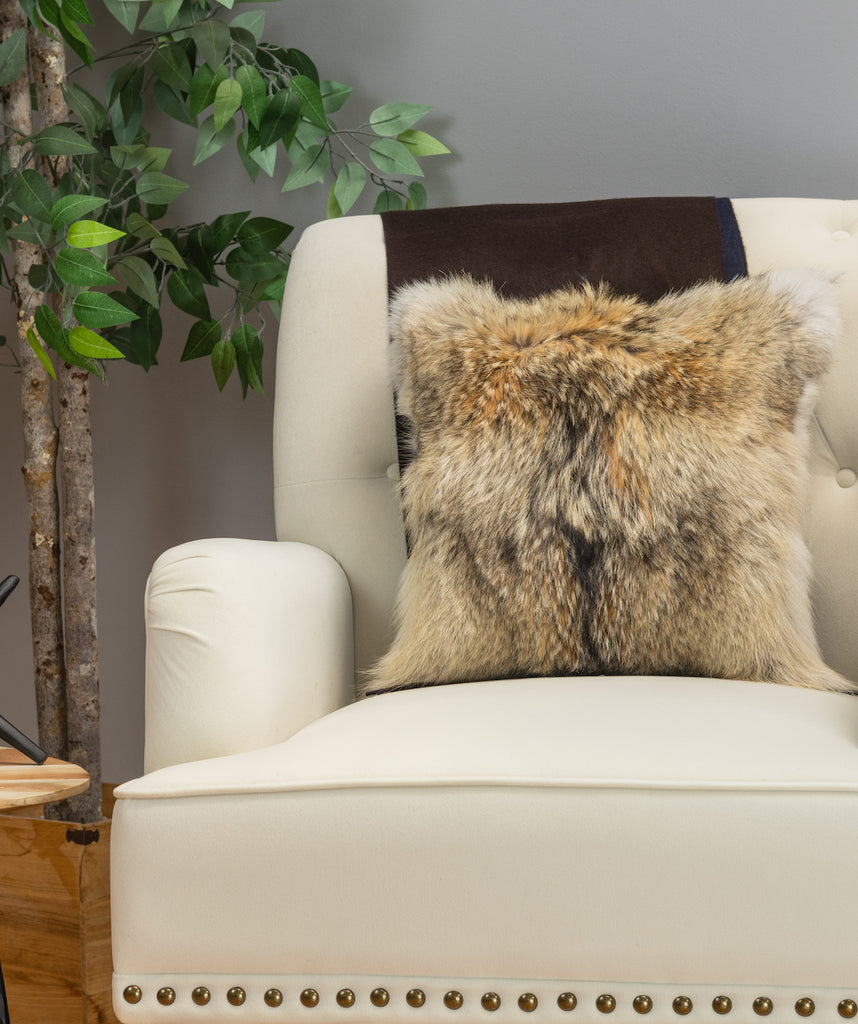 coyote fur pillow on white sofa chair in living room
