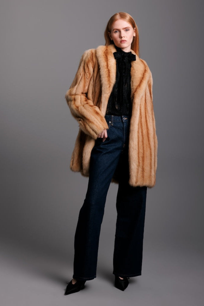 golden sable fur jacket full view worn on woman with dark jeans and blouse