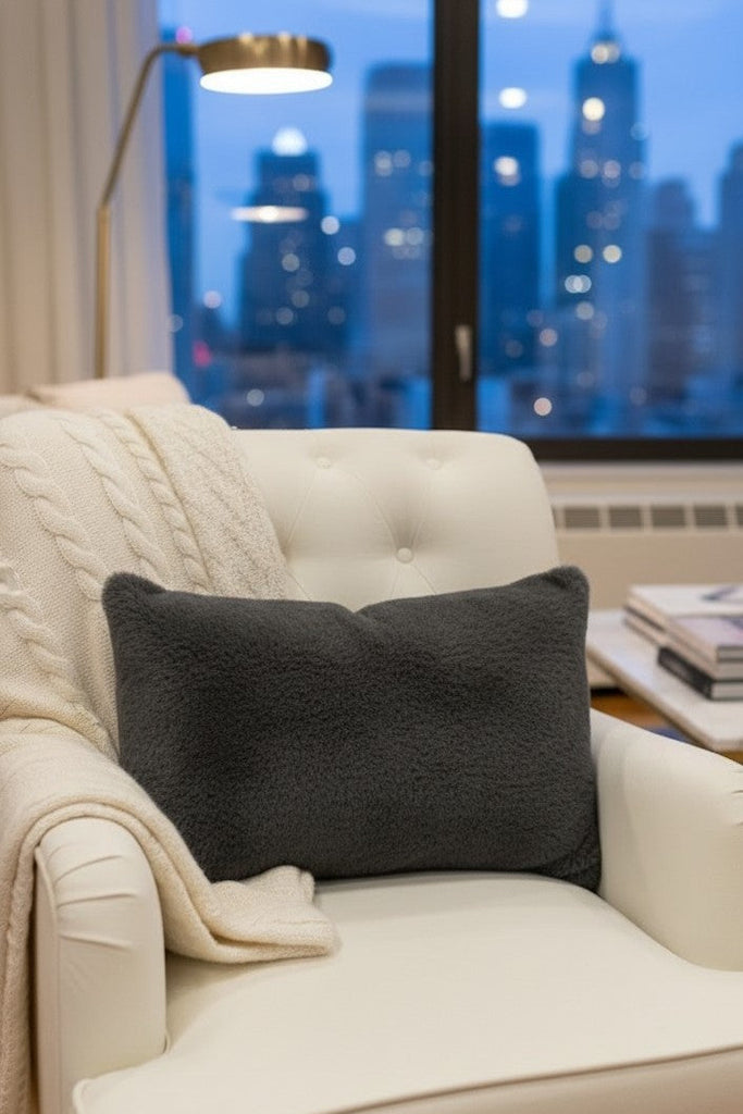 grey loro piana cashfur pillow on a white recliner chari