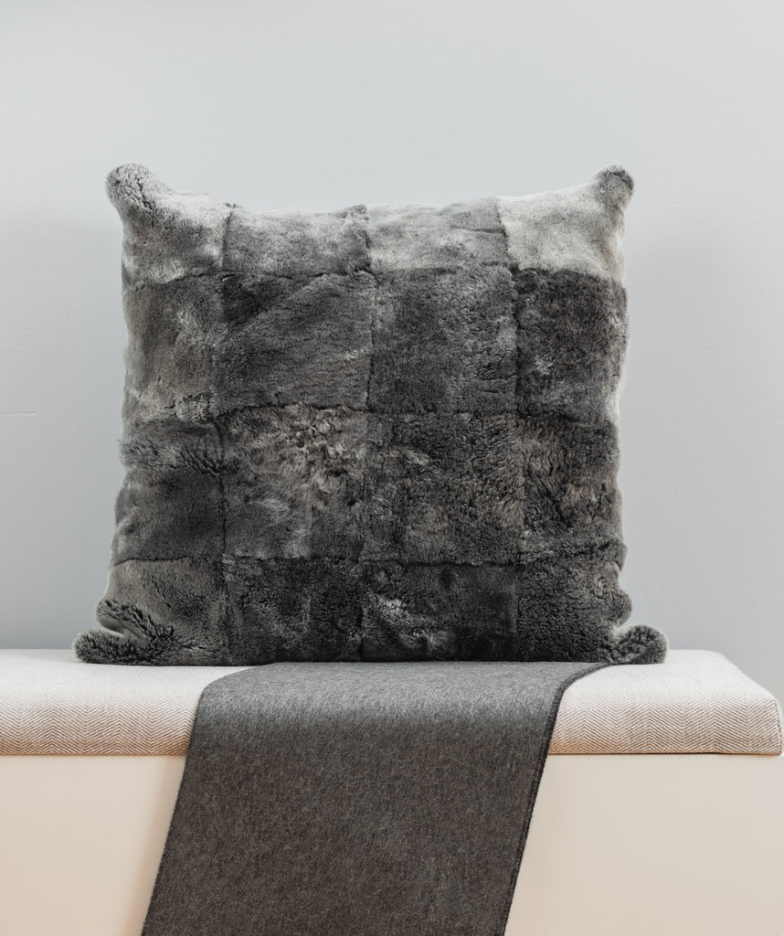 grey shearling fur pillow in square design with backside in cashmere wool pattern