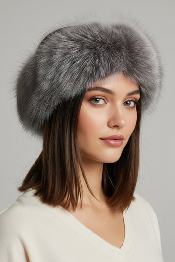 Woman wearing an indigo fox fur headband with grey and blue tones and cream colored sweater.
