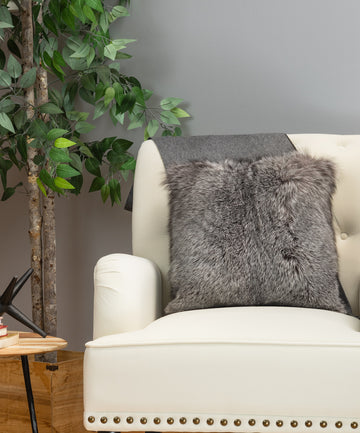 Indigo fox fur pillow on white sofa chair in living room