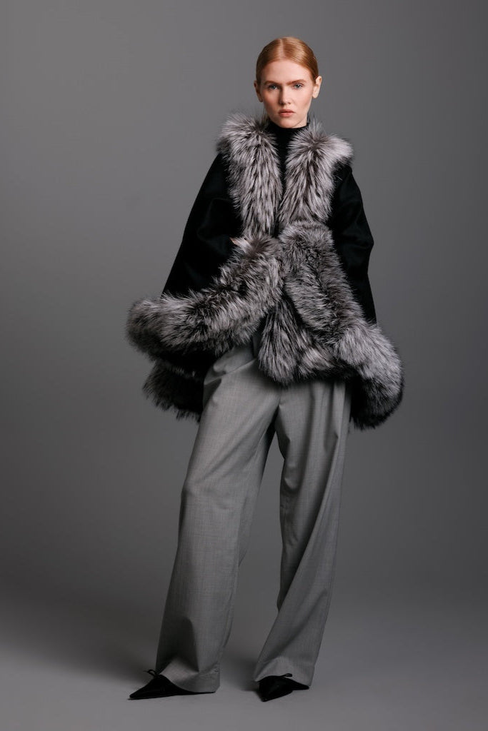 Model wearing a petite size silver fox petite cape with black from trim