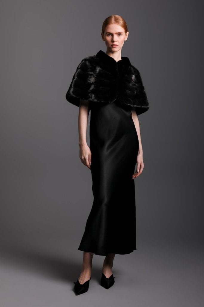 ranch mink capelet worn over the shoulders of a woman in a black tie affair evening gown 