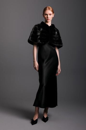 ranch mink capelet worn over the shoulders of a woman in a black tie affair evening gown 