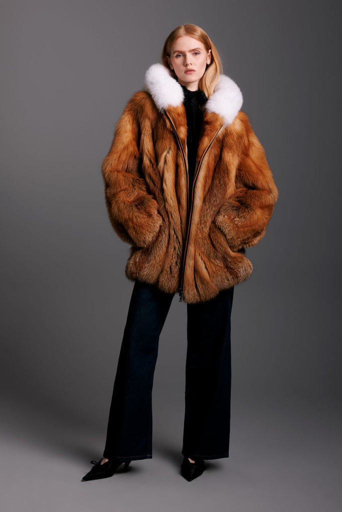 red fox fur parka with hood and fox trim zipper closure on woman with denim jeans