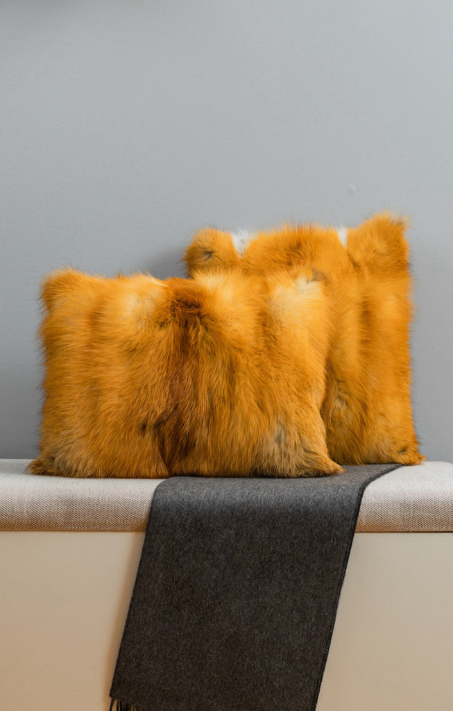 Red Fox Fur throw pillows on inside living room bench