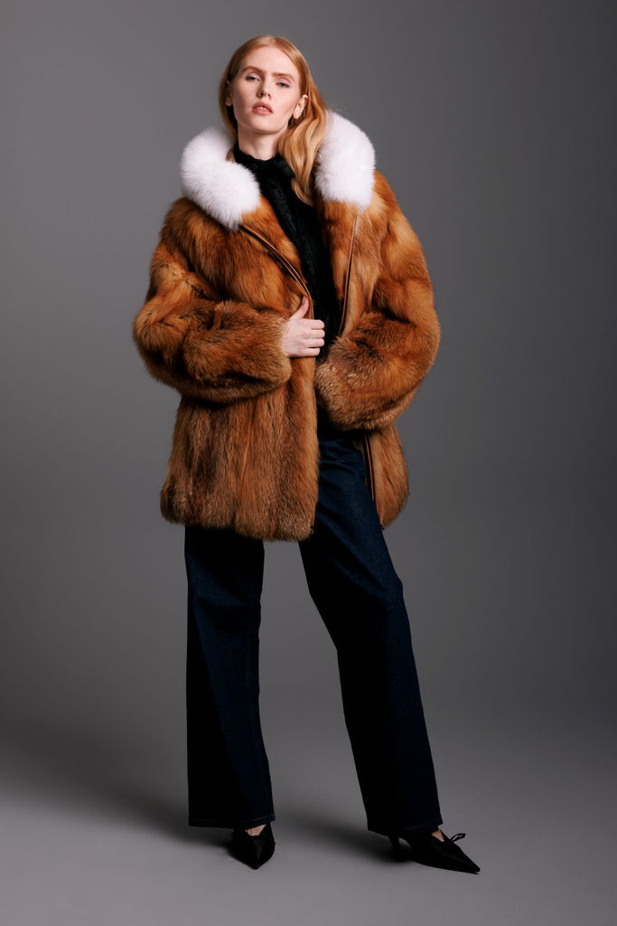 red fox fur hooded parka with white fox trim zipper closure on woman wearing dark jean