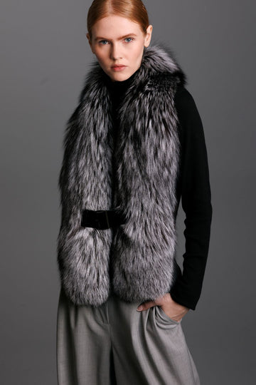 silver fox fur oversized collar with black patent leather closure on woman wearing black sweater and grey pants