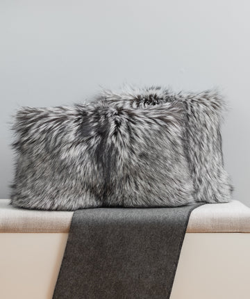 Silver fox fur pillow set on bench for interior design