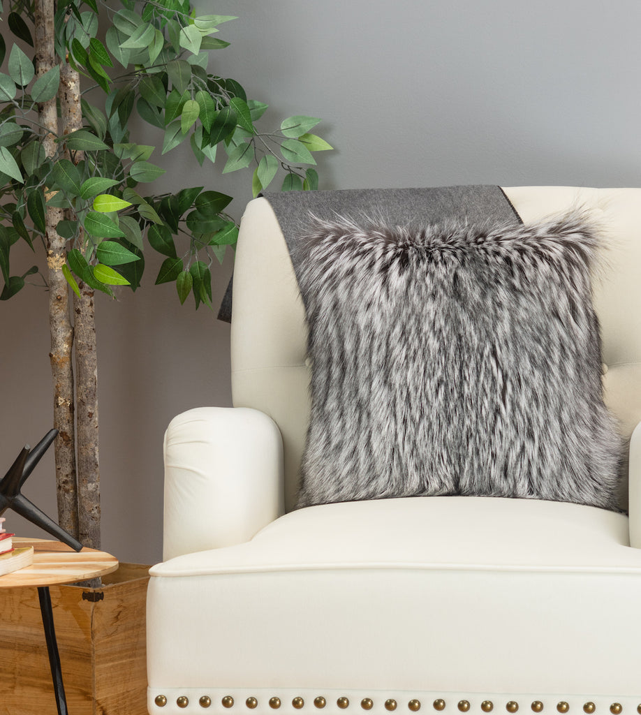 Silver fox fur pillow on white sofa chair in living room