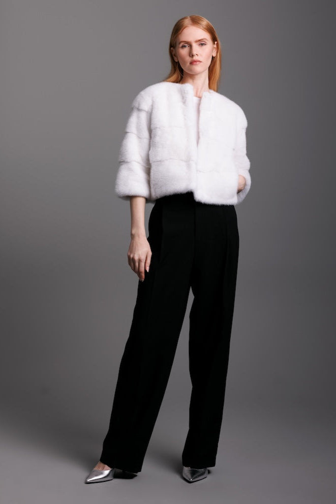 white mink horizontal jacket with 3/4 sleeve on woman wearing black pants and heels