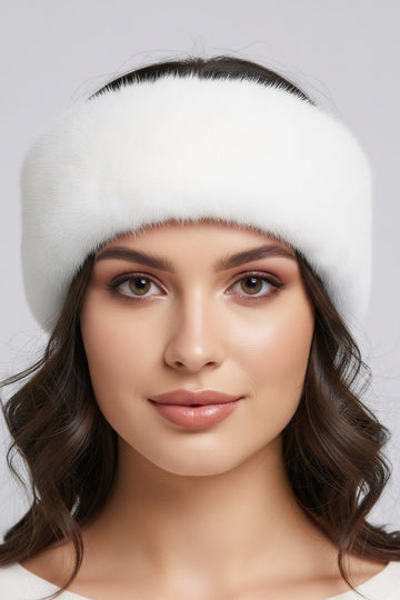 Woman wearing a white headband against a light gray background
