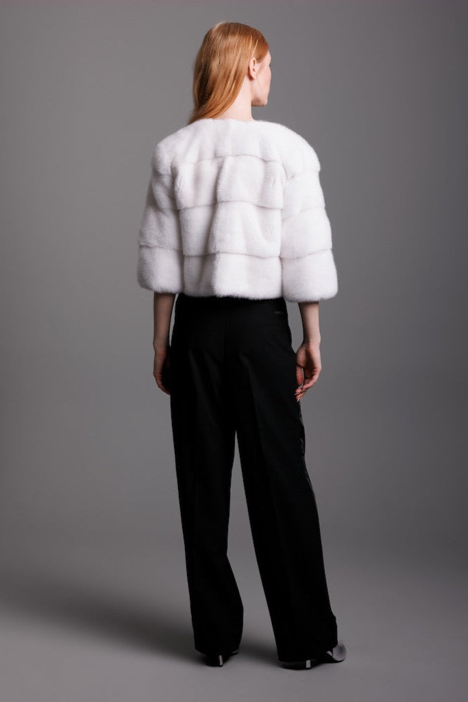 white mink horizontal jacket detail view of back on woman wearing black pants