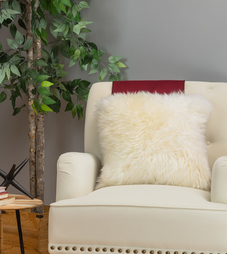 white shearling fur pillow on white sofa living room chair