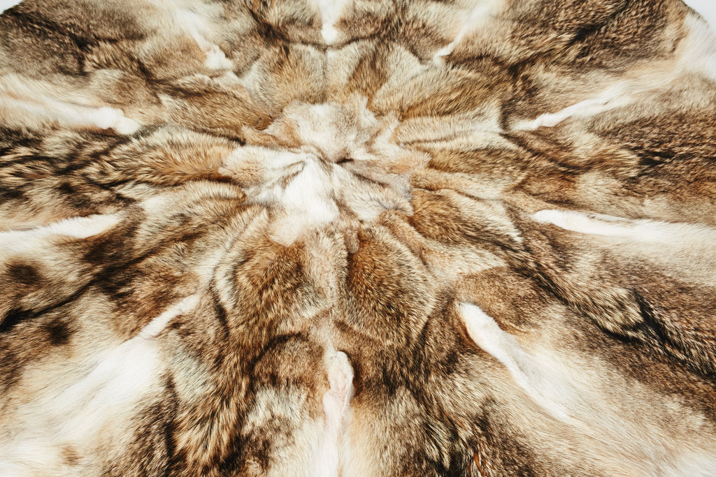 Coyote Fur Round Rug Design next to Barcelona Chair for home interior close up