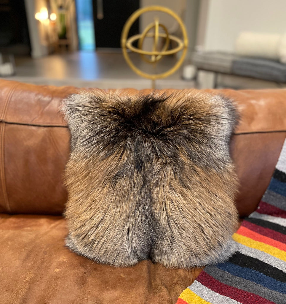 Cross Fox Fur Throw Pillow on Leather Couch in Living Room