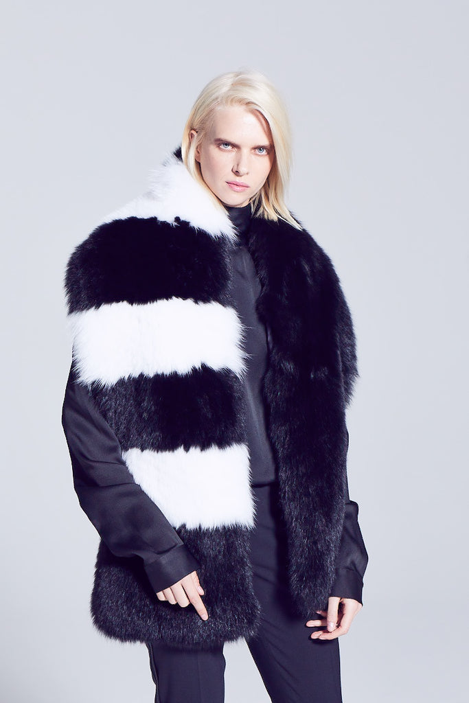 Black and white pattern long fox fur scarf winter evening accessory worn over a black silk shirt