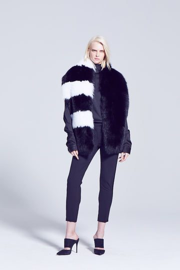 Black and white pattern long fox fur scarf winter evening accessory worn over a black blouse