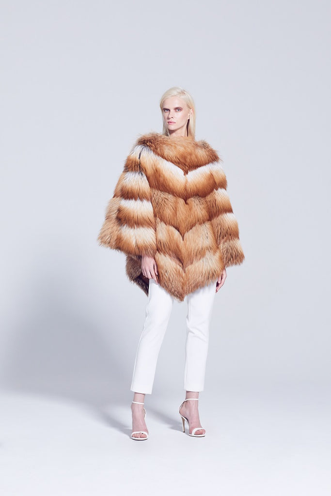 gold fox fur over the head poncho styled with white pants