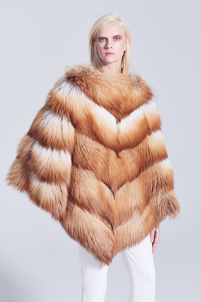 gold fox fur over the head poncho styled with white pants