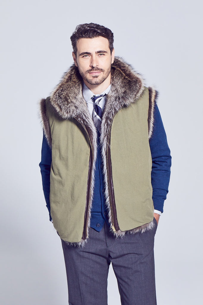 Mens raccoon fur vest with zipper closure and reversible to rainproof lining worn over a sweater