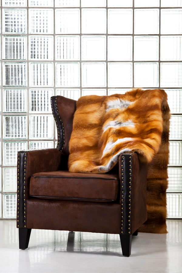 red fox fur blanket layed over chair