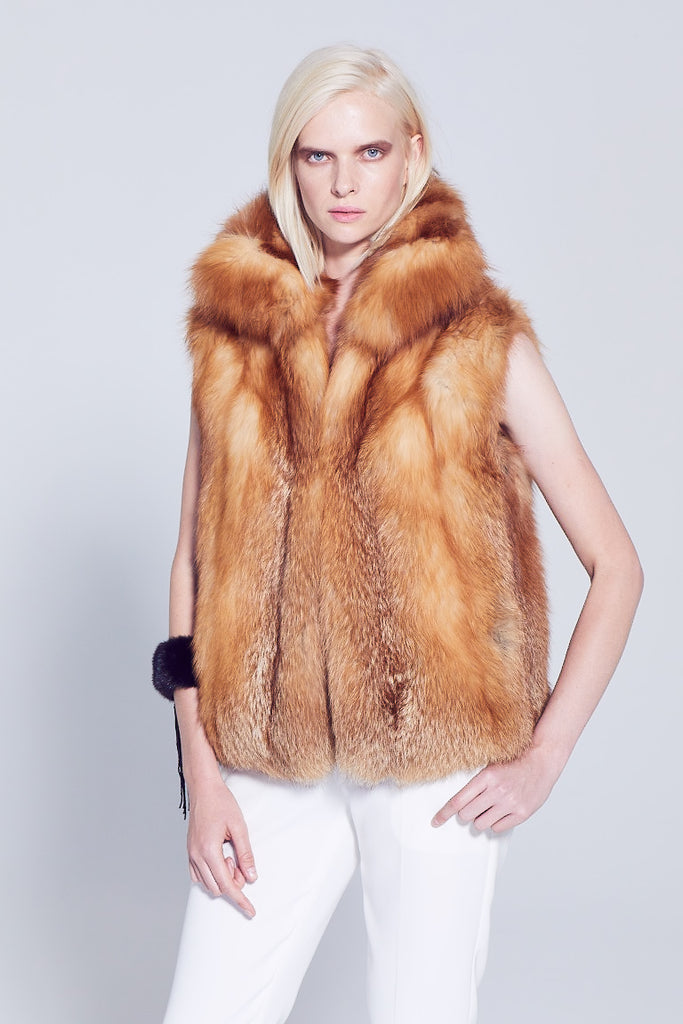 Red fox fur winter vest with cross cut design collar worn with winter white pants