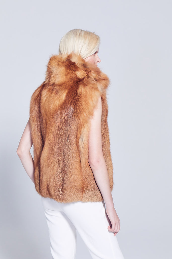 Red fox fur winter vest with cross cut design collar worn with winter white pants back side detail