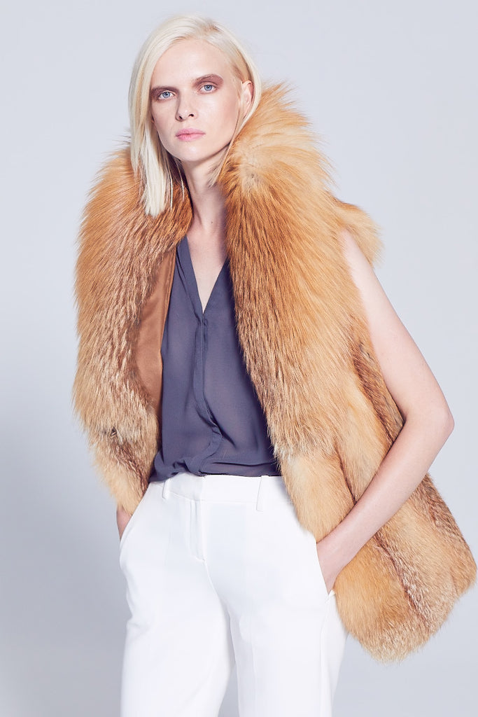 Gold Fox and Red fox fur Vest with shawl collar worn over winter white pants